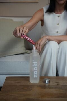 Hydrated woman post workout using creatine for women